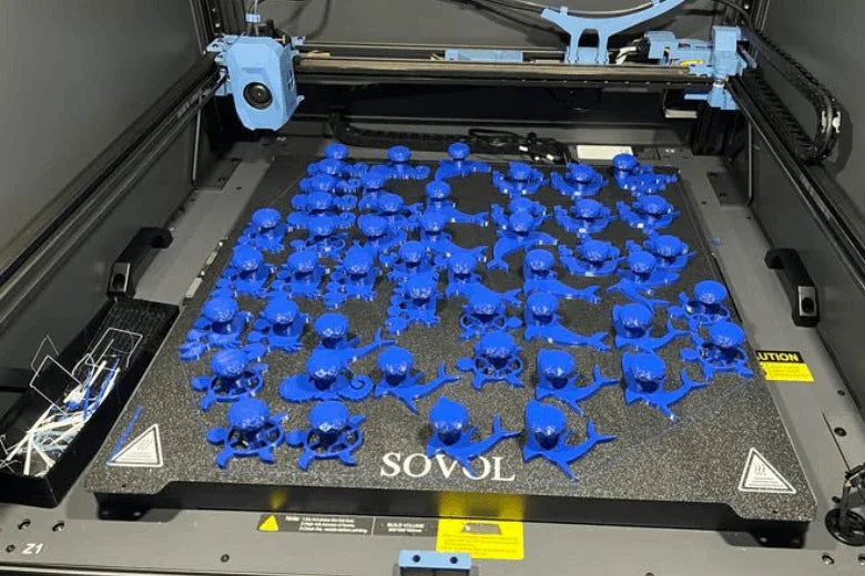 Sovol 3D printer printing multiple blue octopus toys on large print bed