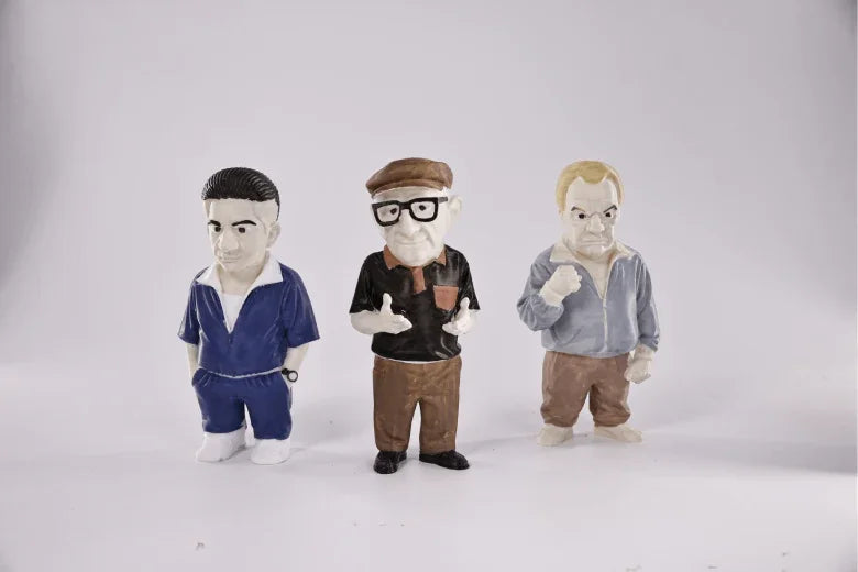 Three 3D printed cartoon figurines of men in casual outfits on a white background
