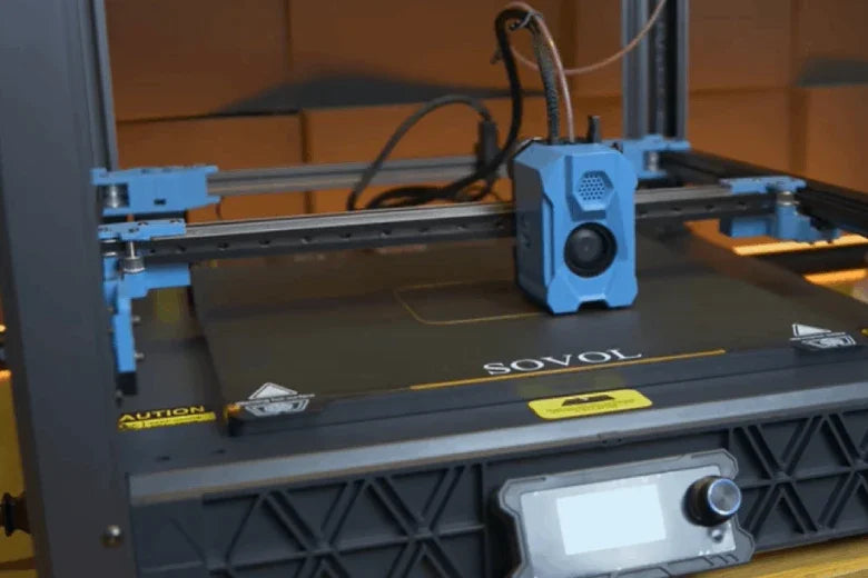 Sovol 3D printer with blue extruder head and touchscreen, in a workshop setting