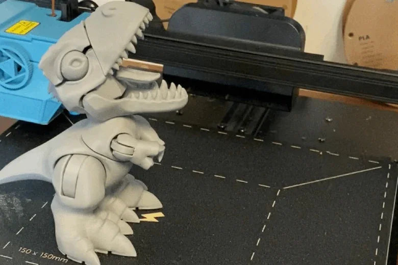 3D printed T-Rex dinosaur figurine on a 3D printer bed