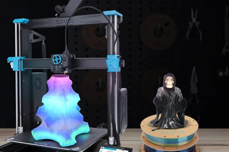 Sovol 3D printer printing multicolor sculpture beside black hooded figurine on spool