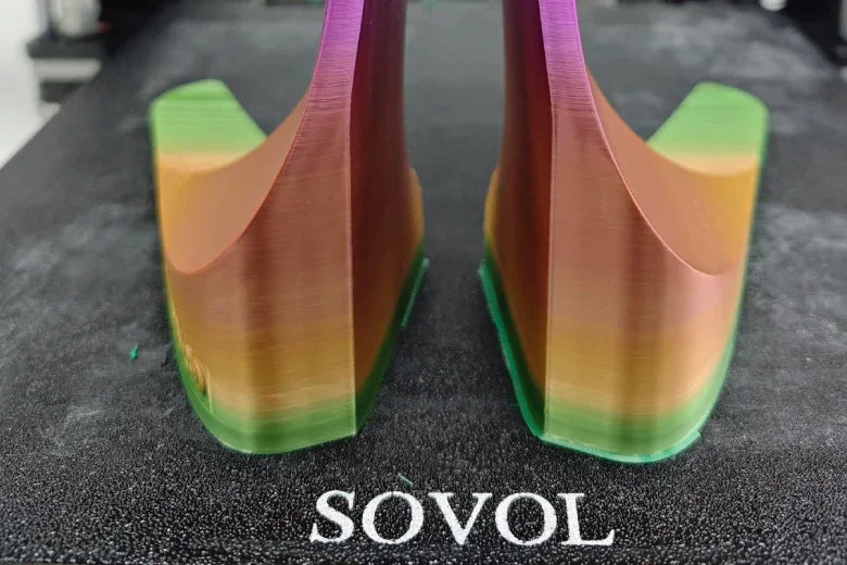 Rainbow gradient 3D prints on SOVOL 3D printer bed, close-up view