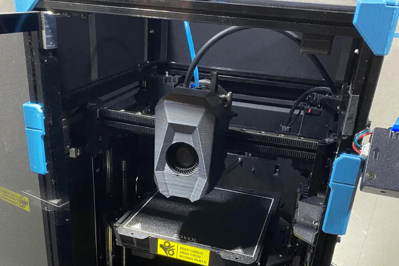 Enclosed 3D printer with filament dryer and black print bed inside a metal frame